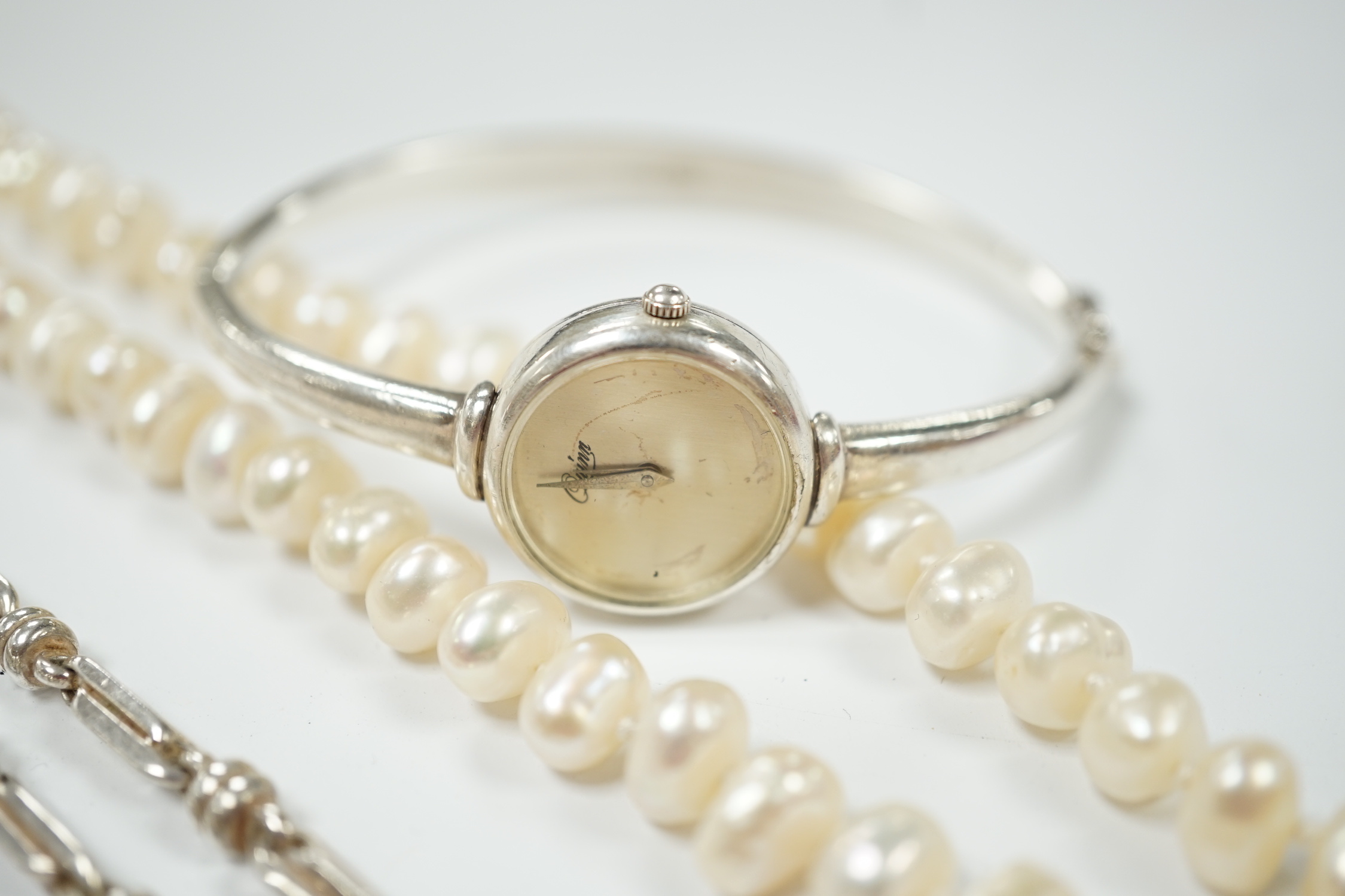 A modern 925 chain, a lady's 925 bangle watch and two cultured pearl necklaces.